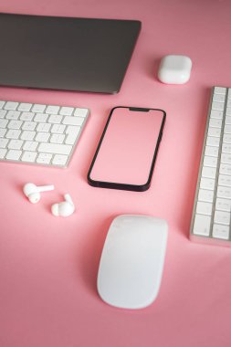 Ofis elektronik aletleri. Akıllı telefon faresi ve laptop. Temiz pech renk arkaplanı.