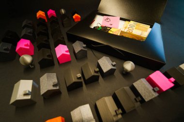 Real estate purchase documents keys money property deal. Conceptual representation of home buying process including financial planning, contract signing and key transfer, with euro cash, model houses and legal folder