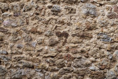 Eski rustik taştan yapılmış bir ortaçağ duvarının arka planı