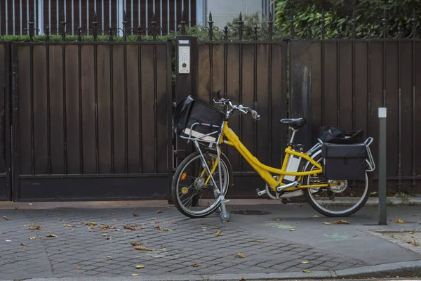 Fransa'da bir binanın girişinin önünde park etmiş bir postacı bisikleti