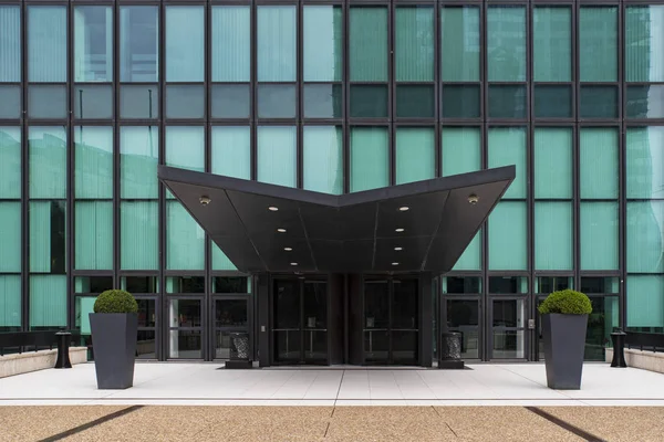 Detail of the entrance to a modern glazed office building