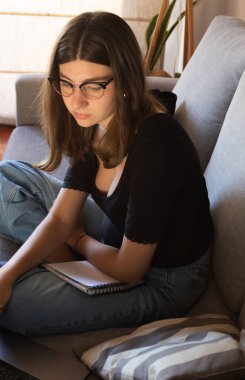 Blonde adolescent studying and working from home, digital learning lifestyle, modern teenager with technology.Real picture. suitable for social media 