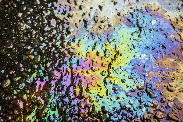 Rainbow Liquid Petrol Pollution Leak on Asphalt Road