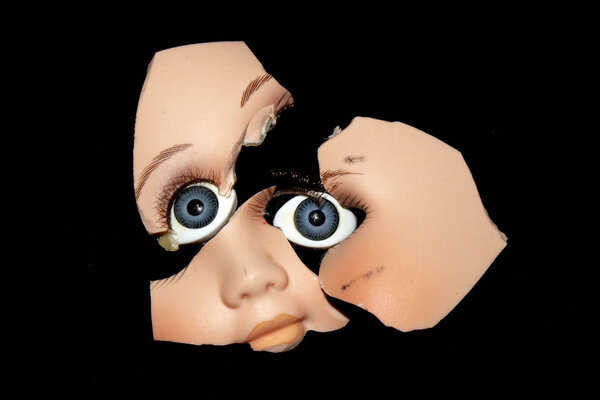 Broken Doll Head Face On Black Background