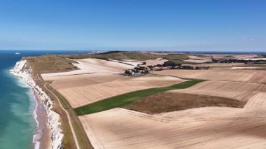 Experience the breathtaking beauty of Cap Blanc Nez in France from an aerial perspective, highlighting the dramatic coastline and vibrant agricultural fields nearby.
