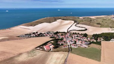 Experience the stunning aerial perspective of Cap Blanc Nez, showcasing dramatic cliffs and picturesque fields near the coast of northern France. The natural beauty unfolds in a captivating panorama.