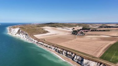 Witness breathtaking cliffs at Cap Blanc Nez, along with golden fields and the vibrant blue waters of the sea in this captivating aerial exploration of France coastline.