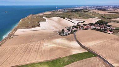 Stunning overhead perspective of Cap Blanc Nez highlights the dramatic coastline and vibrant agricultural landscape of northern France.