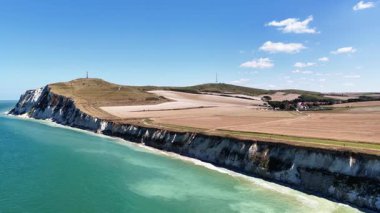 Experience the stunning beauty of Cap Blanc Nez in France with its towering cliffs, sparkling waters, and lush farmlands. This coastal landscape captivates with natural splendor.