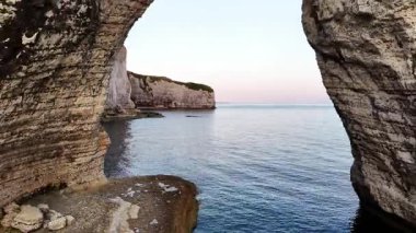 Enjoy the stunning aerial view of Etretat, France, showcasing its famous cliffs and serene ocean at dawn. The beautiful landscape captures the essence of this coastal paradise.