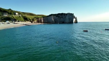 Marvel at the stunning aerial views of Etretat, featuring its iconic cliffs and serene waters. The beautiful landscape showcases natures grandeur in this coastal paradise.
