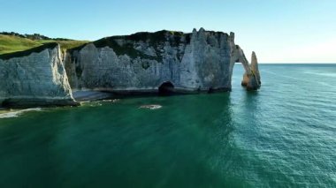 Experience breathtaking views of Etretat, France from above, revealing the famous chalk cliffs and serene blue waters. The natural beauty captivates every onlooker.