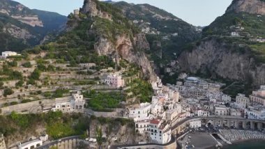 Explore the Amalfi Coast with stunning aerial views showcasing steep cliffs, charming villages, and the serene blue of the Mediterranean Sea. Immerse yourself in this enchanting landscape.
