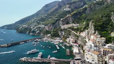 Explore the beautiful Amalfi Coast in Italy through stunning aerial views highlighting its steep cliffs, vibrant waters, and picturesque villages nestled along the shoreline.