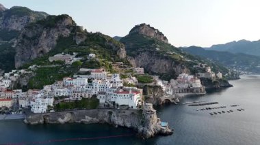 Breathtaking aerial shots reveal the vibrant cliffside towns along the Amalfi Coast in Italy. The shimmering sea complements the dramatic landscape, showcasing natural beauty.