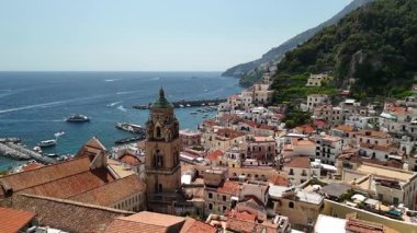 Experience the stunning beauty of the Amalfi Coast from above, showcasing vibrant villages, steep cliffs, and the deep blue waters of the Mediterranean Sea during a sunny day.