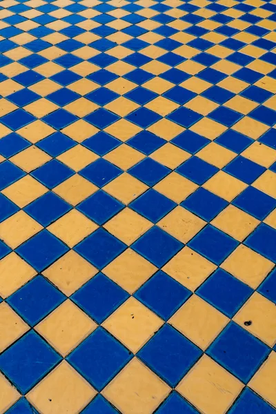Perspective of old style blue and yellow ceramic tiles floor