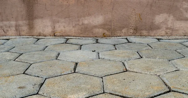 Pattern of street Concrete block with grunge brown concrete wall