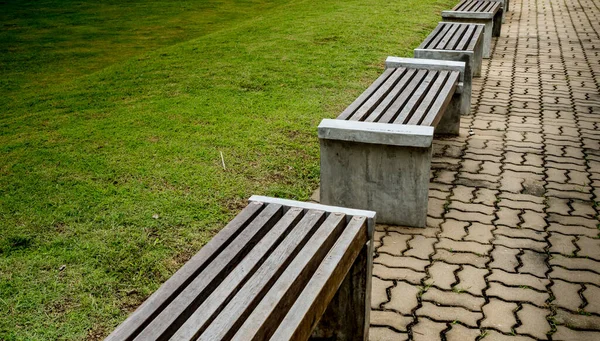 Wood park bench on concrete floor in the park