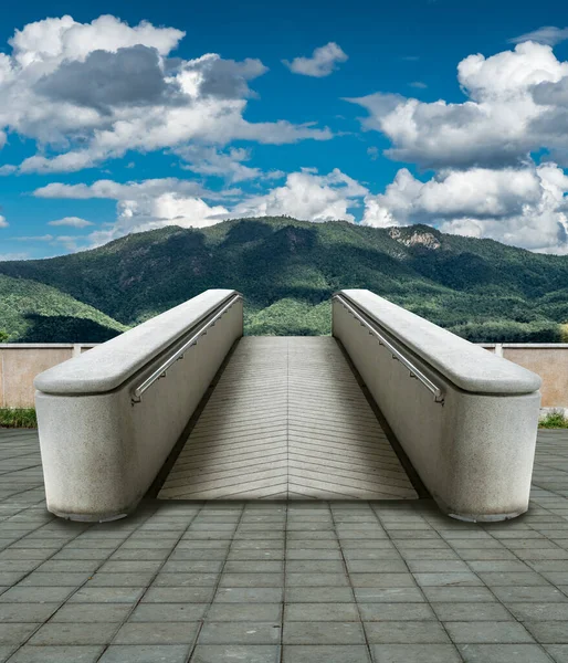 Concrete ramp to mountain with blue sky, concpte idea for freedom or travel