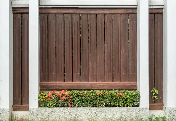 Concrete and wood fence with plants
