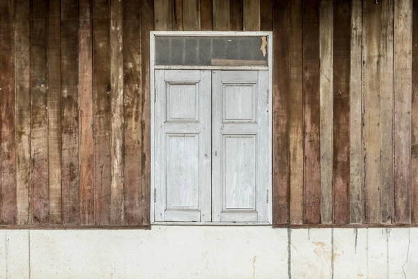 stock image White Closed Windows on old wooden wall