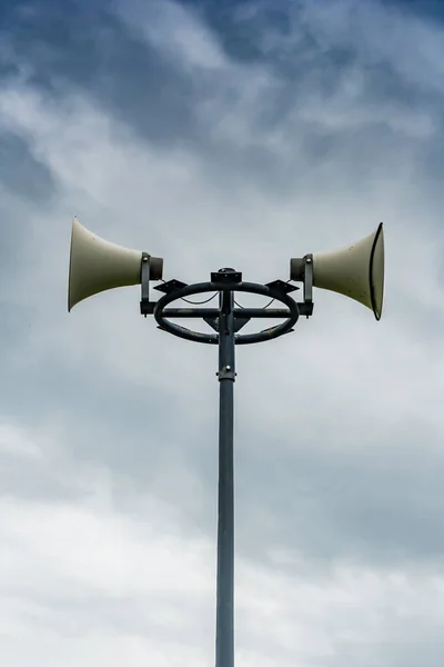 White horn speaker on cloudy background