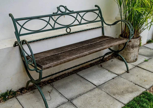 Wood park bench on concrete floor in garden