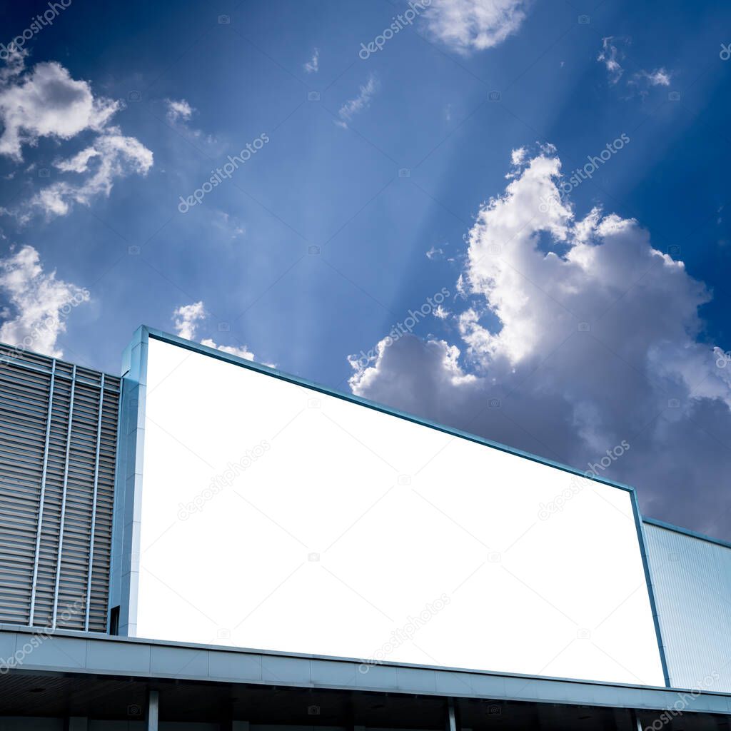 White blank billboard on facade of modern building with white cloud and blue sky for outdoor advertising with clipping path