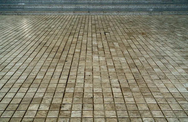 Perspective of gray granite stair with beige tiles floor