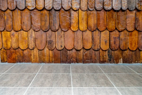 Brown wooden wall with concrete tiles floor