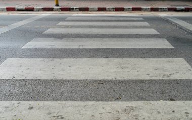 Kaldırımda kırmızı ve beyaz işareti olan asfalt yolda boş yaya geçidi