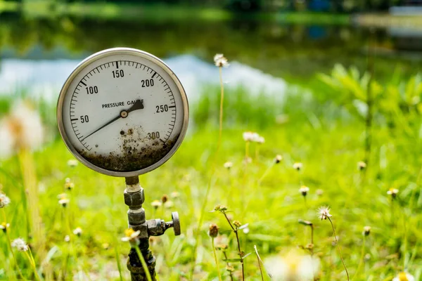 Water pressure gauge on green nature background — Stock Image Water Pressure Gauge Green Nature Background Stock Photo