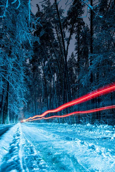 Freezelight, Time-lapse, Headlights of a car on a winter road at night.
