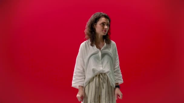 Curly Girl Rejoices Shows Cool Red Background Successful Satisfied — Stock Video