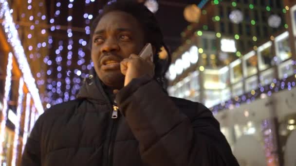 African Man Talks Smartphone City — Stock Video