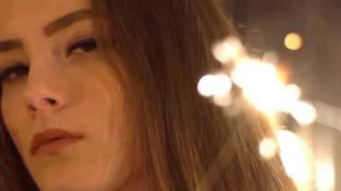 Elinde Bengal ışığı olan bir kızın yakın çekim portresi..