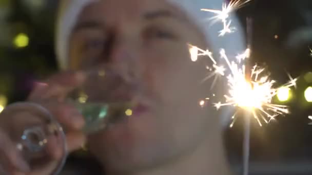 Christmas Man Drinks Glass Sparkling Wine Balls Tree Background — Stock Video
