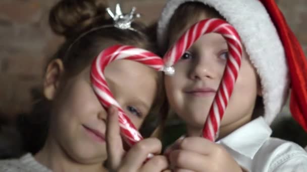 Cute Little Boy Girl Makes Heart Shape Two Candy Canes — Stock Video