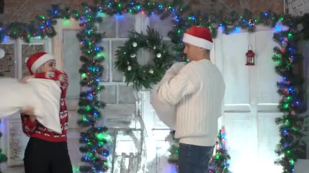 Young Couple Fights Pillows Christmas — Stock Video