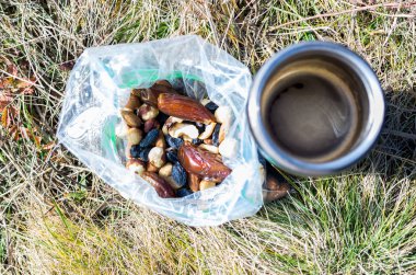 Snack from a variety of nuts. Coffee and nuts. Snack in the hike. clipart