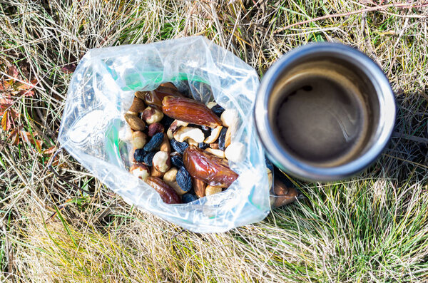 Snack from a variety of nuts. Coffee and nuts. Snack in the hike.