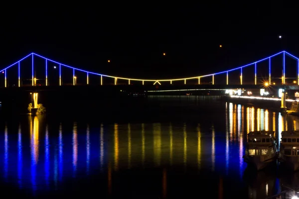 Striking a bridge across the river. The bridge in the center of Kyiv. Bright bridge across the Dnieper River.