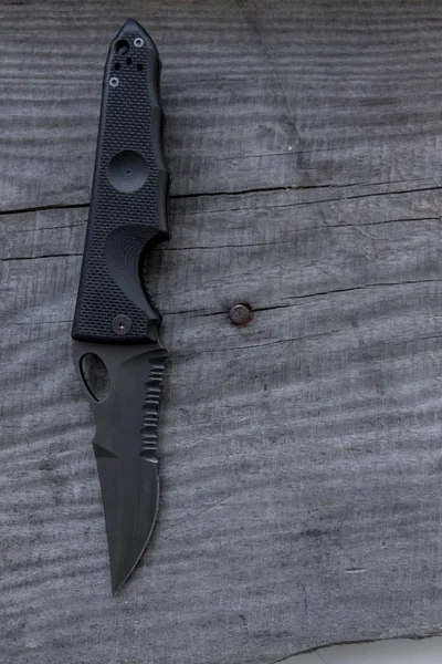 Tactical knife with bullets. Left side. Black knife.