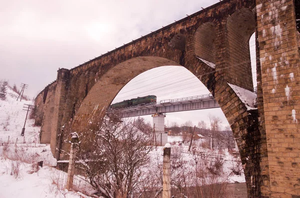 Brick old bridge. Bridge Viaduct in Vorokhta. Winter.