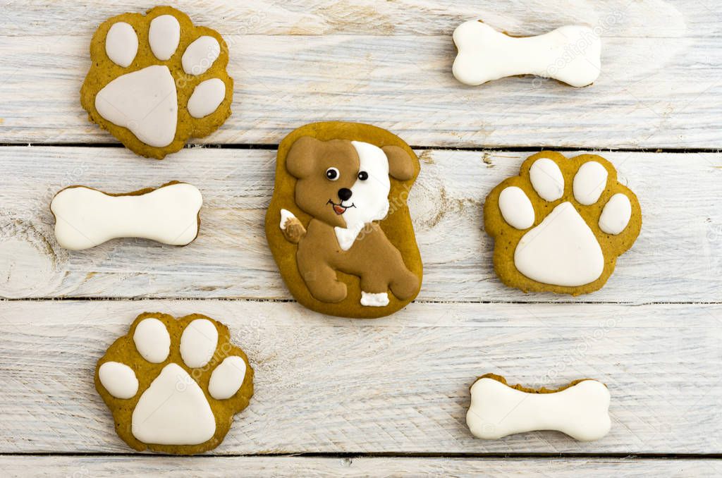 Spotted dog, paw prints and bones. Sweet cakes. White background