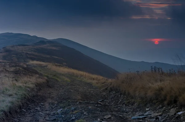 Night in the mountains. Sunset. The sky is the color of blood.