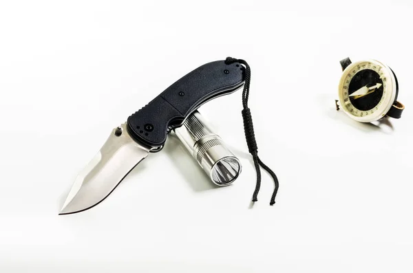 Folding knife and flashlight. Pocket knife and flashlight. Lantern and compass.