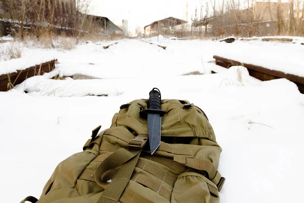 Tactical knif on sand back pack. Military