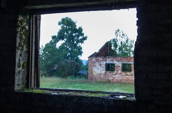 View from the window. View of an abandoned house. Collapsed house.